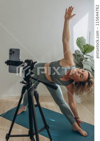 A 50-year-old woman doing online yoga at home A 50-year-old woman doing online yoga at home 115644762