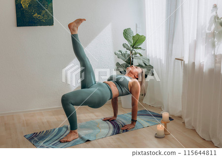A 50-year-old woman doing online yoga at home A 50-year-old woman doing online yoga at home 115644811
