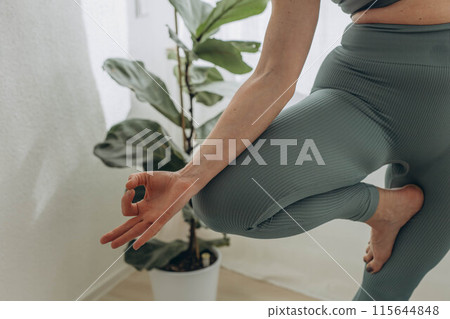 A 50-year-old woman does yoga at home A 50-year-old woman does yoga at home 115644848