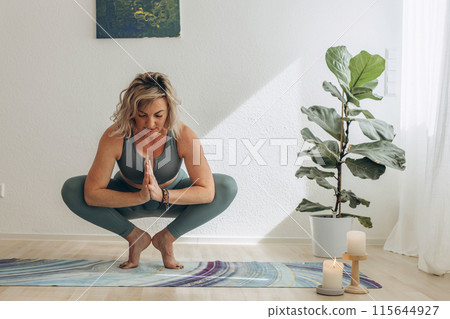 A 50-year-old woman doing online yoga at home A 50-year-old woman doing online yoga at home 115644927