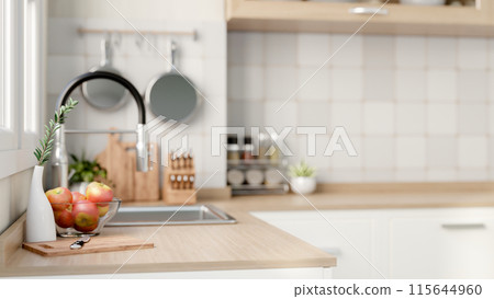 A close-up side view image of a hardwood kitchen countertop in a contemporary, minimalist kitchen. 115644960