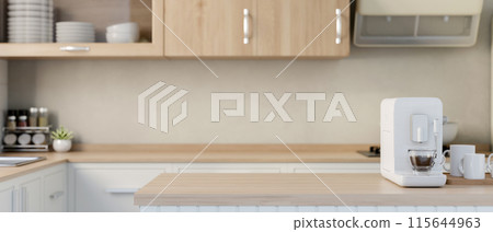 A minimal white espresso machine on a wooden kitchen island in a contemporary minimalist kitchen. 115644963