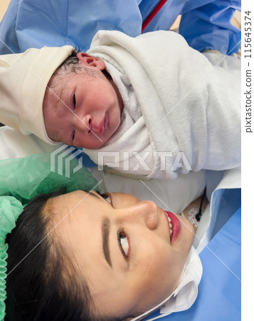 first sight of mother and newborn baby after the Cesarean section in operation room first sight of mother and newborn baby after the Cesarean section in operation room 115645374