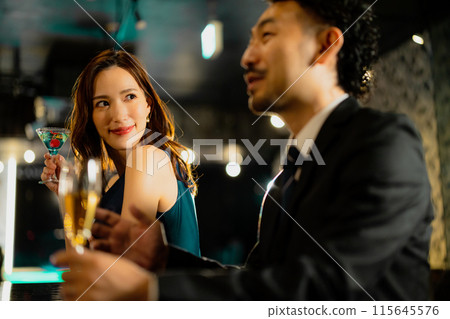 Men and women drinking at a bar Men and women drinking at a bar 115645576