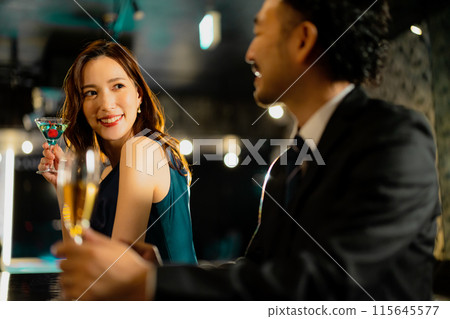 Men and women drinking at a bar 115645577