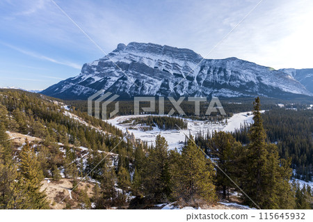 Banff National Park beautiful landscape. Panorama view Mount Rundle valley forest and frozen Bow River in winter. Hoodoos Viewpoint, Canadian Rockies. 115645932