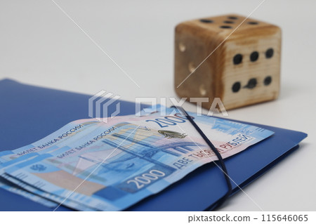 Wooden model cube on the background of banknotes. 115646065