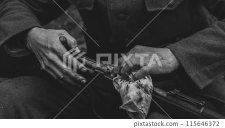 World War II German Soldier Cleaning Rifle. Soldier Preparing Weapon. German Military Ammunition Of A German WW2 Soldier 115646372