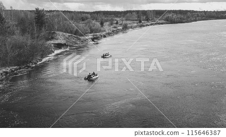 Men Dressed As US American Soldiers Of USA Infantry Of World War II carry out rafting on rubber boats In spring Autumn Day. Group of Soldiers people are preparing to disembark. Aerial view elevated 115646387