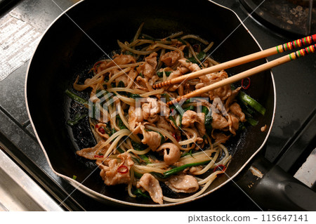 Pork chive bean sprouts being cooked 115647141