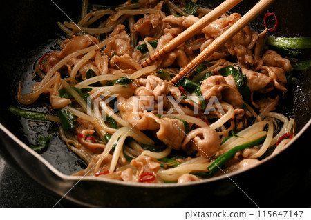 Pork chive bean sprouts being cooked 115647147