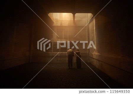 Dark concrete room with warm light 115649350