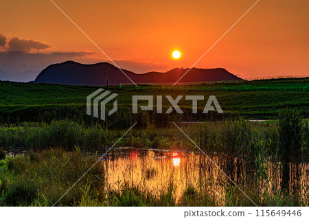 Evening view of the Soni Plateau on the border between Nara and Mie prefectures: the sun setting over the mountainside and the plateau bathed in a golden hue 10 115649446