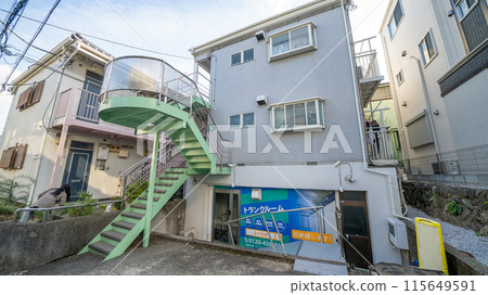 The exterior of a wooden apartment building for women 115649591