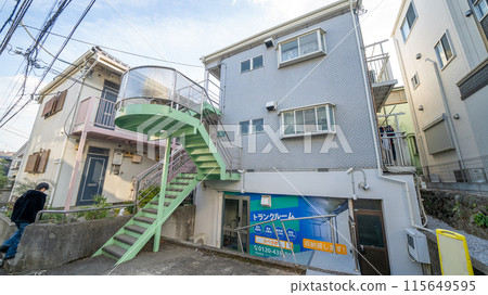 The exterior of a wooden apartment building for women The exterior of a wooden apartment building for women 115649595