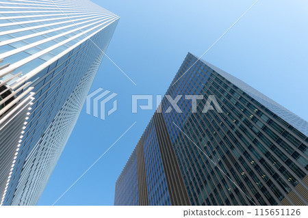 Skyscrapers towering against the blue sky Skyscrapers towering against the blue sky 115651126