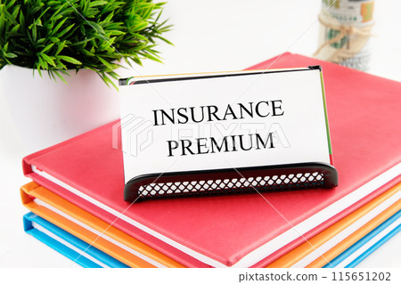 INSURANCE PREMIUM concept text. INSURANCE PREMIUM written on the card on the stand INSURANCE PREMIUM concept text. INSURANCE PREMIUM written on the card on the stand 115651202