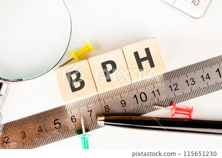 BPH - Benign Prostatic Hyperplasia symbol. Medical and BPH concept. BPH word is made up of wooden cubes on a white background in a composition with a ruler, pen and calculator 115651230