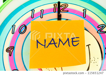 Brand and naming concept. NAME word on the sticker on the background of the watch face 115651247