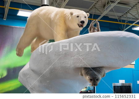 Polar Bear Sculpture on luggage carousel of Yellowknife airport terminal building. Yellowknife, Northwest Territories, Canada. 115652331