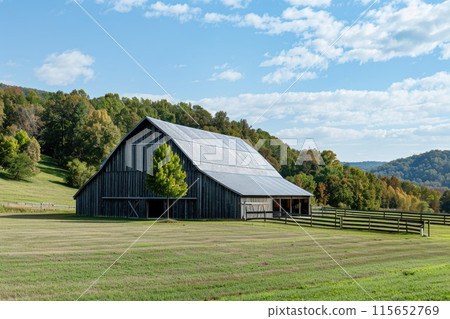 Rustic barn in verdant farmland under blue sky 115652769