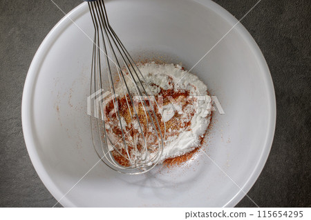 spices with salt and baking powder are mixed in a white bowl spices with salt and baking powder are mixed in a white bowl 115654295