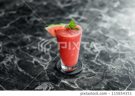 Elegant glass of watermelon cocktail with mint garnish on a sleek marble surface, refreshing treat Elegant glass of watermelon cocktail with mint garnish on a sleek marble surface, refreshing treat 115654351