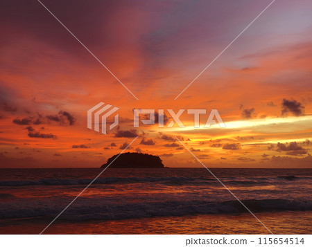 Beautiful sunset on the ocean shore with a view of the islands Beautiful sunset on the ocean shore with a view of the islands 115654514