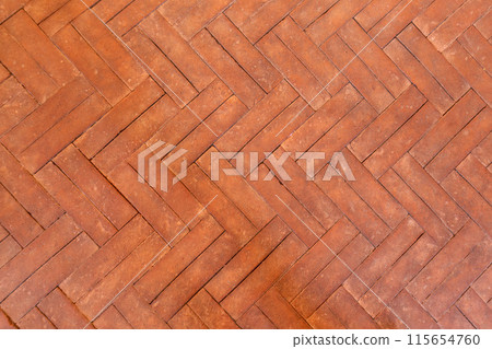 Old handmade ceramic parquet laid in a classic herringbone pattern. Floor background. Old handmade ceramic parquet laid in a classic herringbone pattern. Floor background. 115654760