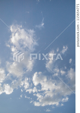 Summer sky is painted with electric blue hues, adorned with fluffy white cumulus clouds floating. Summer sky is painted with electric blue hues, adorned with fluffy white cumulus clouds floating. 115654771