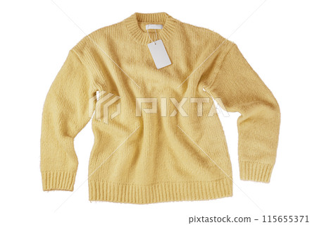 Yellow flying crumpled women autumn knitted sweater with label tag isolated on white background 115655371