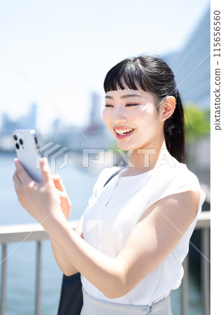 Young business woman with smartphone Young business woman with smartphone 115656560