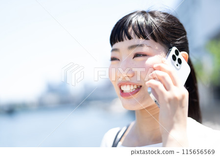 A young woman talking on a smartphone 115656569