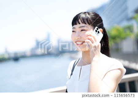 A young woman talking on a smartphone 115656573