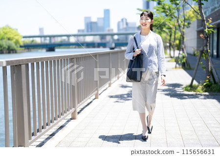 A young lady walking along the river A young lady walking along the river 115656631