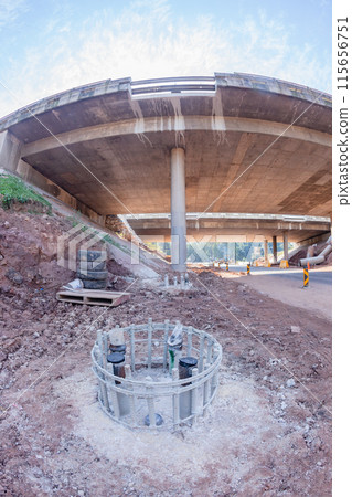 Bridge Construction Foundation Steel Columns Inserted Close-Up Bridge Construction Foundation Steel Columns Inserted Close-Up 115656751