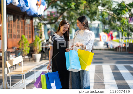 Friends Enjoying a Shopping Day Out in the City Friends Enjoying a Shopping Day Out in the City 115657489