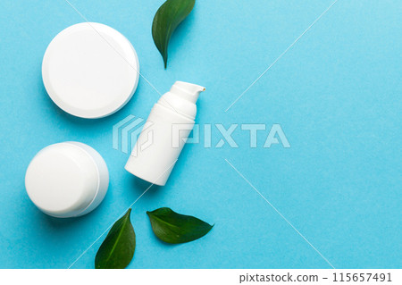 Organic cosmetic products with green leaves on color background. Copy space, flat lay Organic cosmetic products with green leaves on color background. Copy space, flat lay 115657491