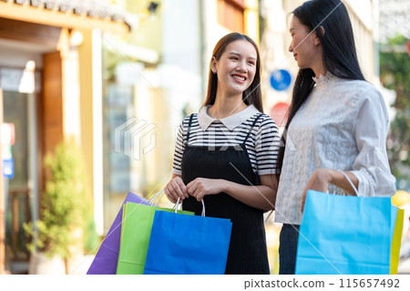 Friends Enjoying a Shopping Day Out in the City Friends Enjoying a Shopping Day Out in the City 115657492