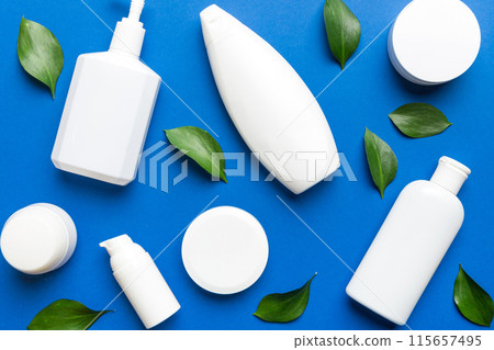 Organic cosmetic products with green leaves on color background. Flat lay Organic cosmetic products with green leaves on color background. Flat lay 115657495