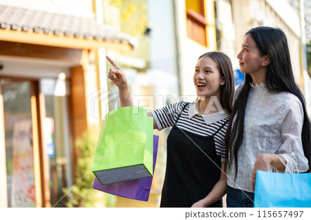 Friends Enjoying a Shopping Day Out in the City Friends Enjoying a Shopping Day Out in the City 115657497