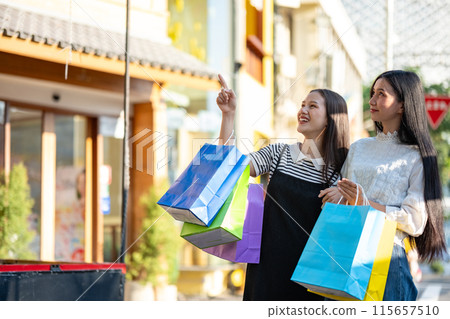 Friends Enjoying a Shopping Day Out in the City Friends Enjoying a Shopping Day Out in the City 115657510