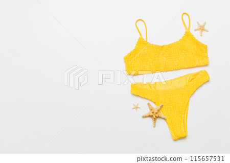 Traveler accessories, women summer bikini set swimsuit on table background with empty space for text. Travel vacation concept. Flat lay, top view Female sexy swimwear 115657531
