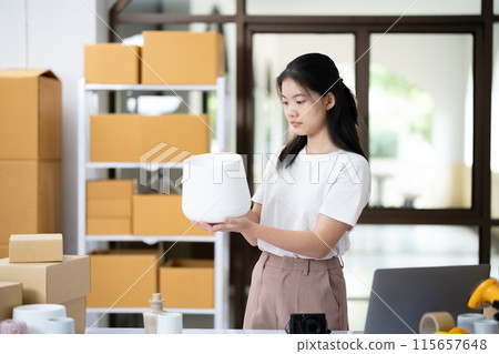Entrepreneur Conducting Product Quality Check in Workspace Entrepreneur Conducting Product Quality Check in Workspace 115657648