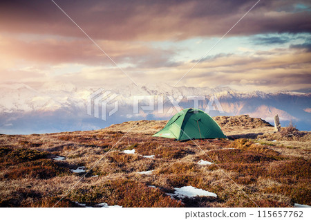 Tent against the backdrop of snow-capped mountain peaks. The view from the mountains to Mount Ushba Mheyer, Georgia. Europe 115657762