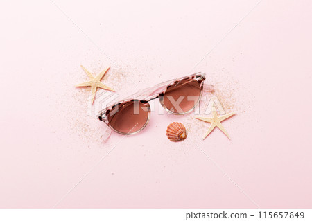 sunglasses with seashell lying on table background. Sunglasses on summer background. Top view flat lay with copy space for text sunglasses with seashell lying on table background. Sunglasses on summer background. Top view flat lay with copy space for text 115657849