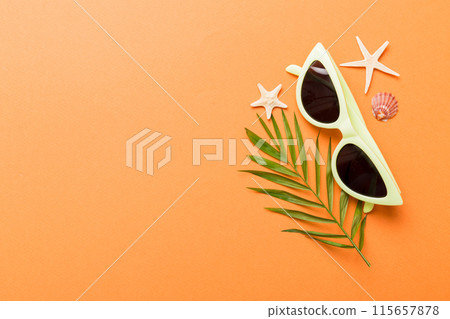 sunglasses with seashell lying on table background. Sunglasses on summer background. Top view flat lay with copy space for text sunglasses with seashell lying on table background. Sunglasses on summer background. Top view flat lay with copy space for text 115657878