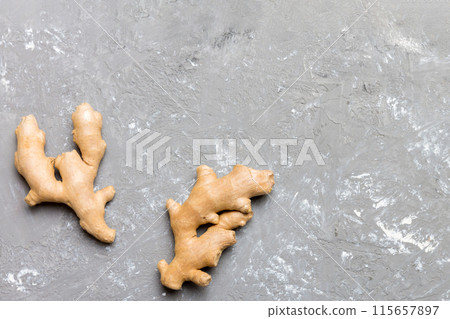 Finely dry Ginger powder in bowl with green leaves isolated on colored background. top view flat lay 115657897