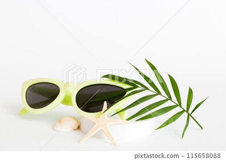 sunglasses with seashell lying on table background. Sunglasses on summer background. Top view flat lay with copy space for text 115658088