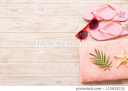 Summer holiday concept. Top view of beach towel, flip flop and sunscreen cream on table Top view with copy space for text 115658132